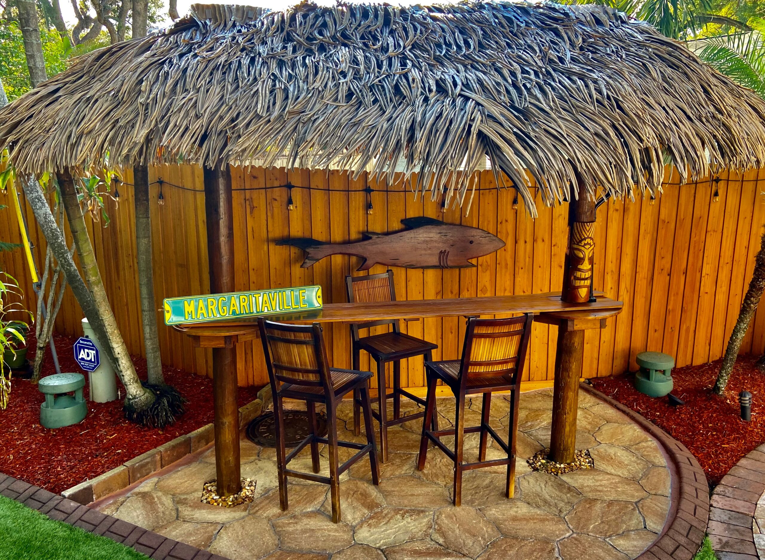 Backyard Tiki Hut with Thatched Roof and Wood Posts