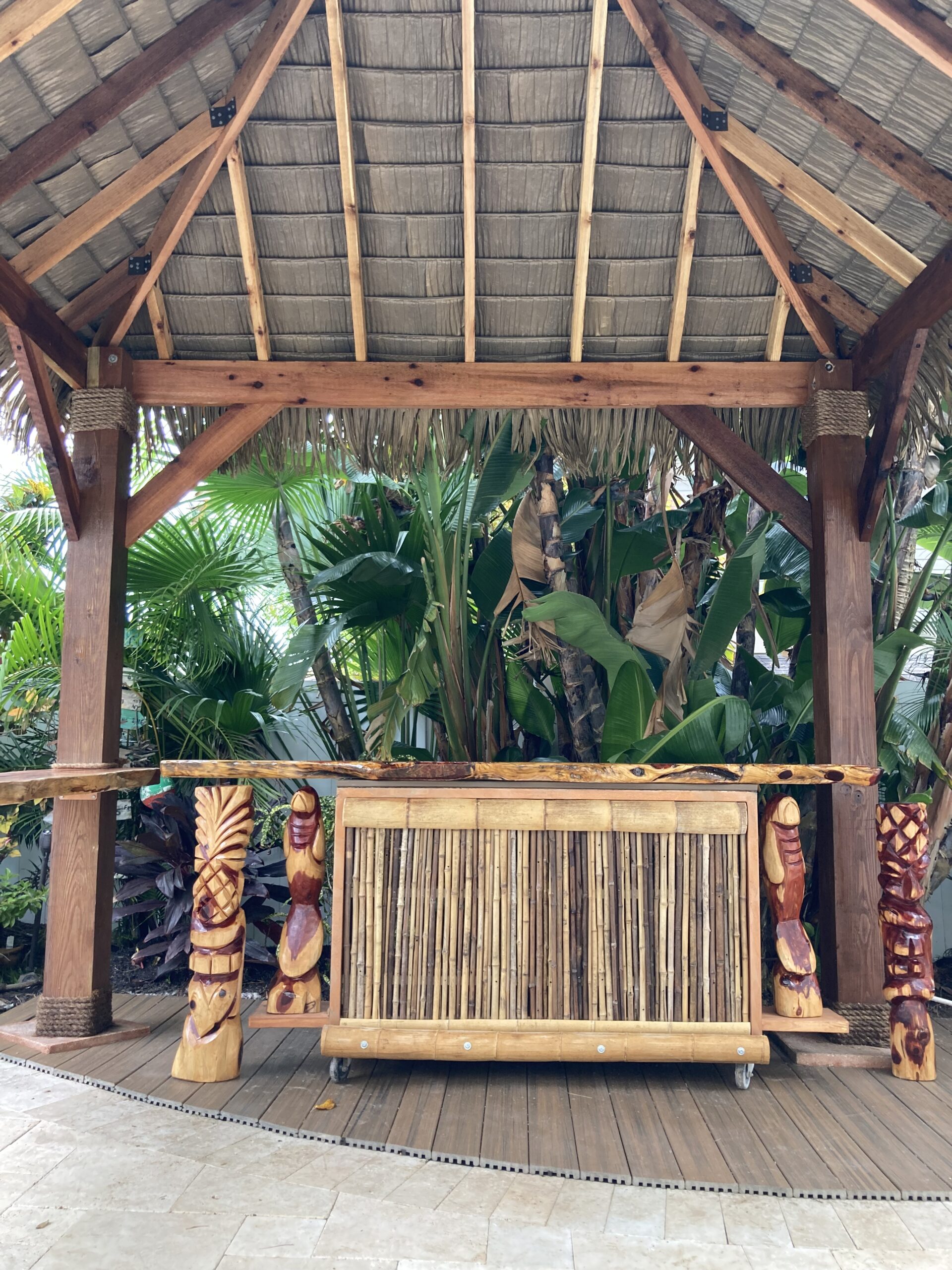 Backyard Tiki Hut with Bamboo Bar and Carved Posts
