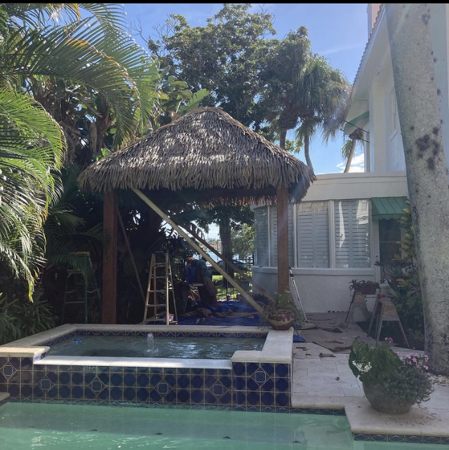 Backyard Tiki Hut with Palm Thatch and Tropical Landscaping