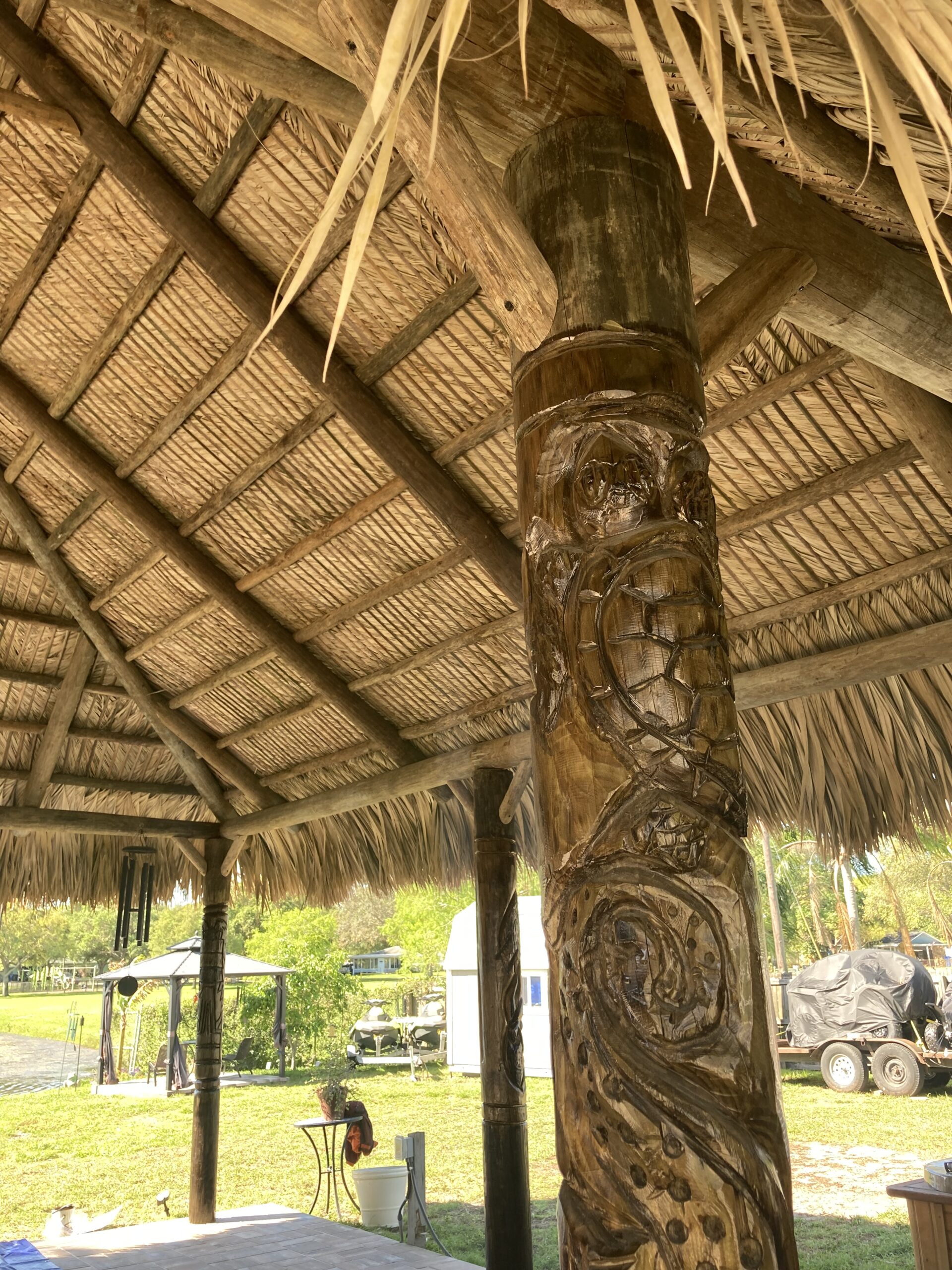 Tiki Hut Interior with Carved Totem Post and Palm Thatch Roof