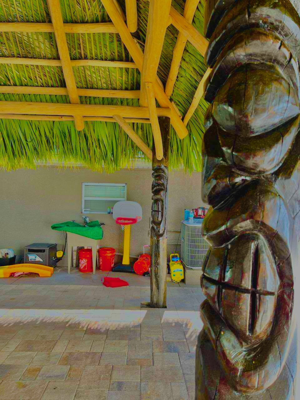 Tiki Bar Interior with Bamboo Counter and Carved Tiki Post