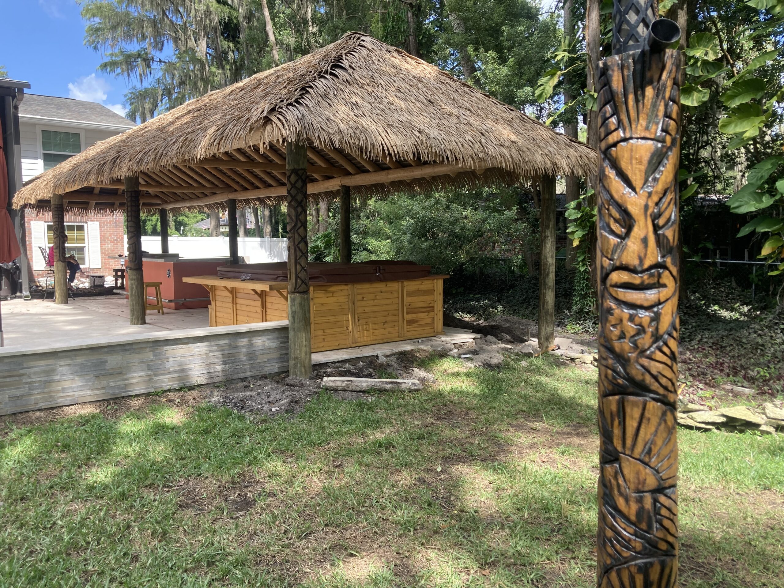 Backyard Tiki Hut with Palm Thatch and Carved Post
